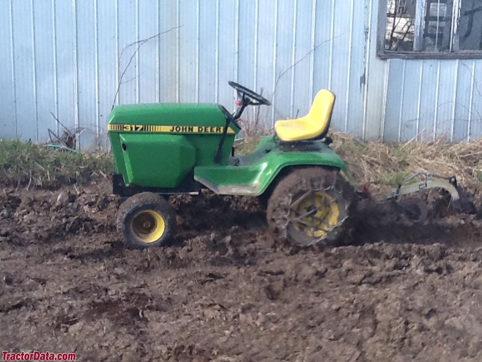 John Deere 317 with plow, left side